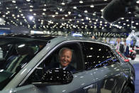 FILE - President Joe Biden drives a Cadillac Lyriq through the showroom during a tour at the Detroit Auto Show, Sept. 14, 2022, in Detroit. Biden turns 80 on Sunday, Nov. 20. (AP Photo/Evan Vucci, File)
