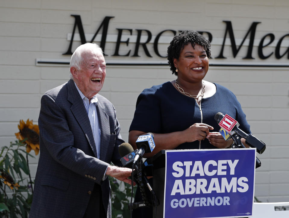 Former President Jimmy Carter and Democratic gubernatorial candidate Stacey Abrams speak to reporters during a news conference to announce her rural health care plan Tuesday, Sept. 18, 2018, in Plains, Ga. (AP Photo/John Bazemore)