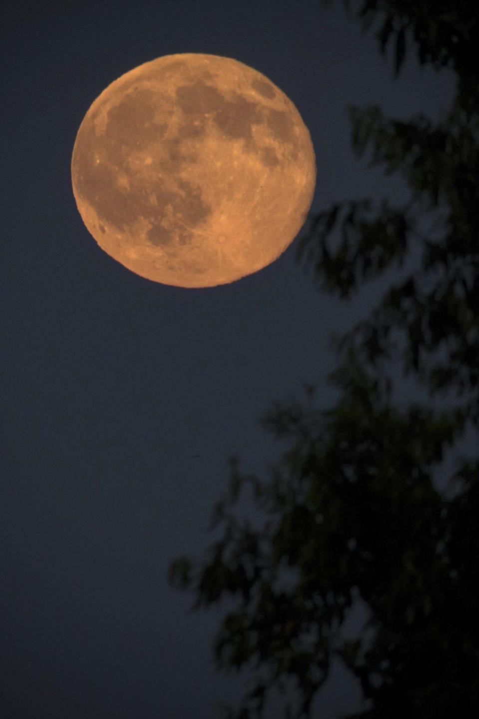 A full moon glitters during the shortest night of the year near Nagykanizsa, 208 kms southwest of Budapest, Hungary, late Monday, June 20, 2016. (Szilard Gergely/MTI via AP)