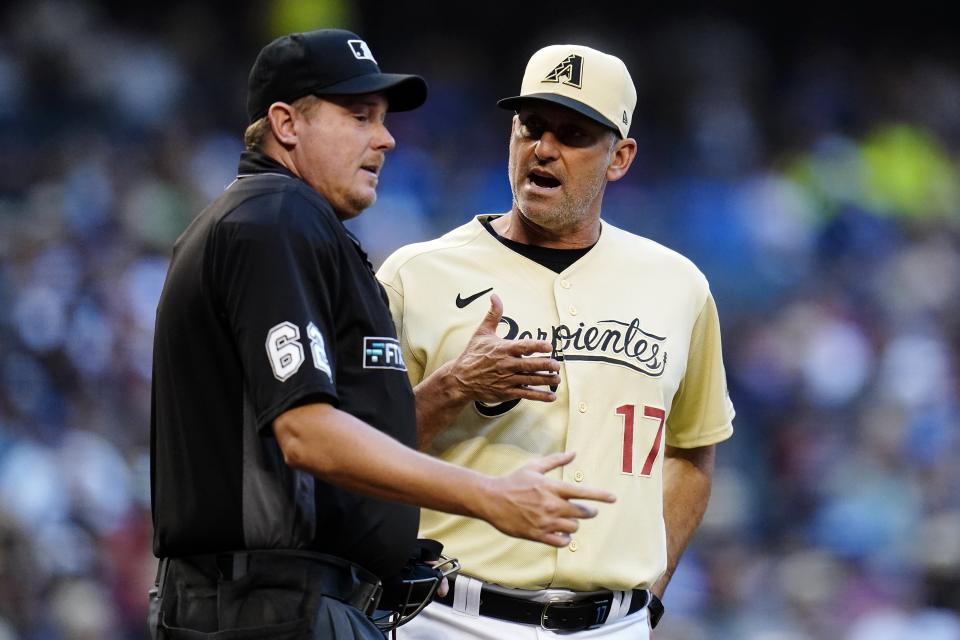 Arizona Diamondbacks manager Torey Lovullo (17) argues with umpire Chad Whitson, left, during the third inning of a baseball game against the Los Angeles Dodgers Saturday, Sept. 25, 2021, in Phoenix. (AP Photo/Ross D. Franklin)