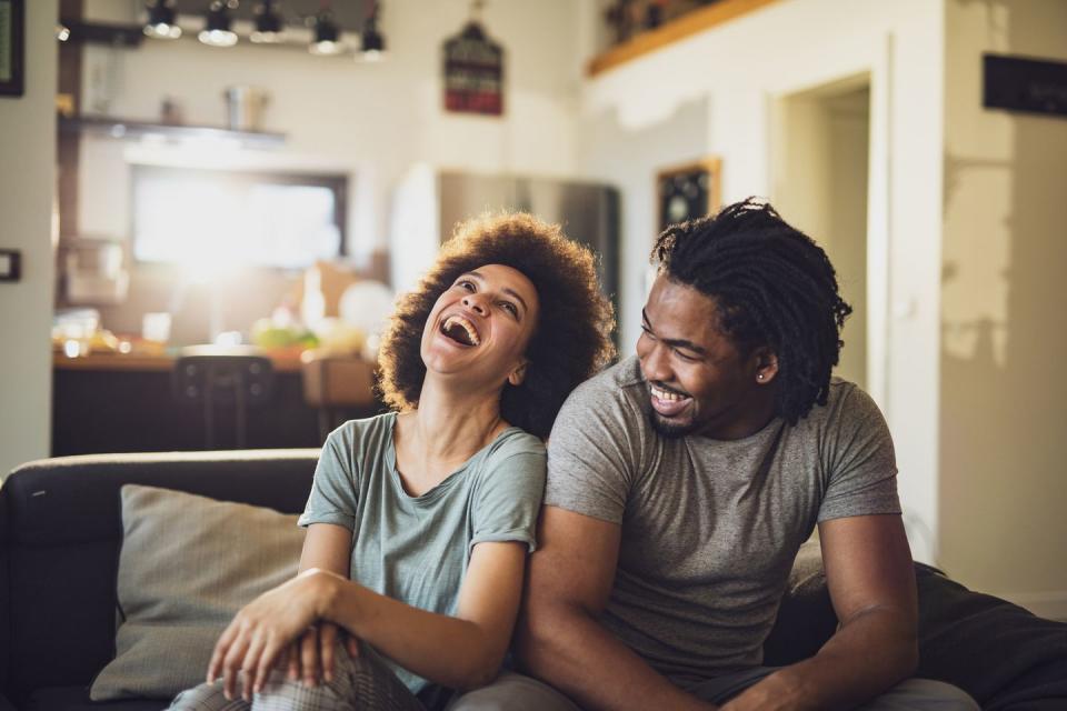 young cheerful african american couple in the living room