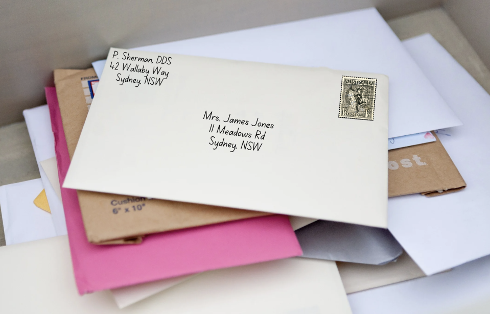 A pile of various envelopes and letters with visible addresses