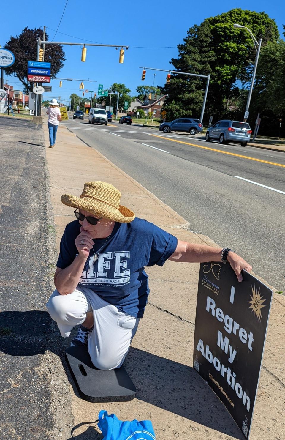 Christy Ballor cries and prays outside of the Planned Parenthood in Canton on Friday morning in response to the Supreme Court's abortion decision. A native of Alliance, Ballor said she had an ill-advised abortion at 17. She is regional director of Silent No More.