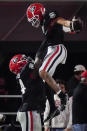 Georgia offensive lineman Justin Shaffer, left, picks up wide receiver Jermaine Burton to celebrate Burton's touchdown against Mississippi State during the first half of an NCAA college football game Saturday, Nov. 21, 2020, in Athens, Ga. (AP Photo/Brynn Anderson)