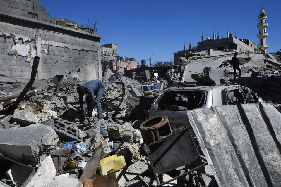 Palestinians inspect the rubble of destroyed buildings after an Israeli airstrike in Nusseirat refugee camp, central Gaza Strip, on Thursday, Feb. 29, 2024. (AP Photo/Adel Hana)