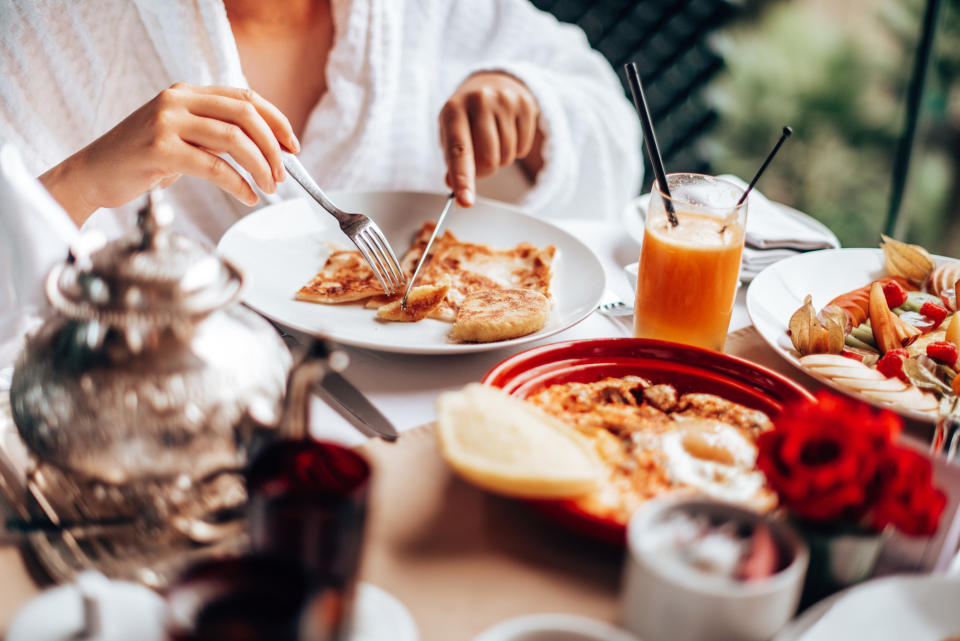 A person eating a big breakfast