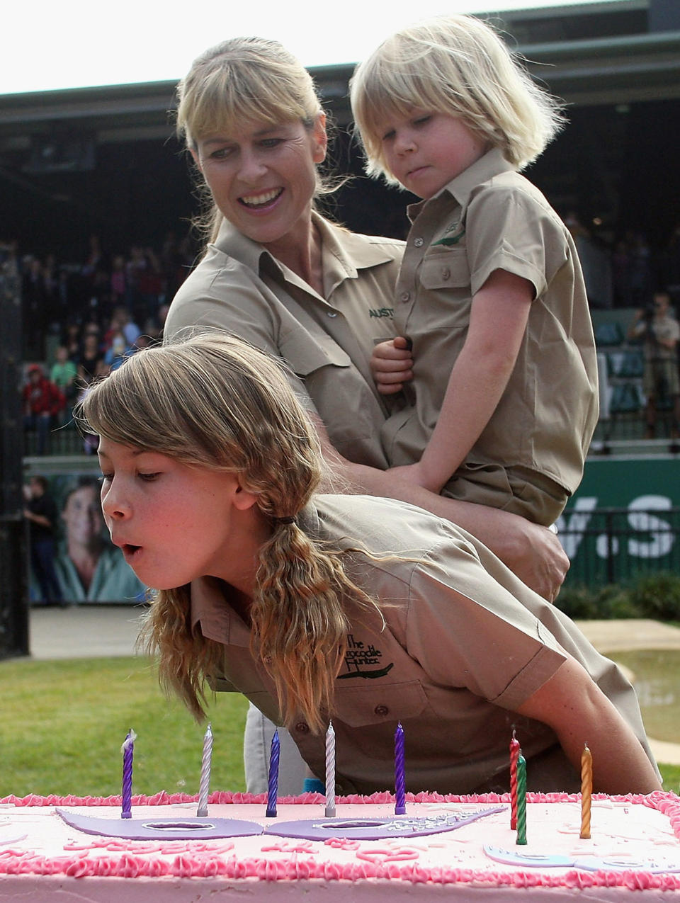 TV personality Bindi Irwin blows out the candles on her birthday cake as she celebrates her 11th birthday with her mother Terri Irwin and brother Robert (Bob) Irwin at Australia Zoo on July 24, 2009 in Beerwah on the Sunshine Coast near Brisbane, Australia.  (Photo by Bradley Kanaris/Getty Images)