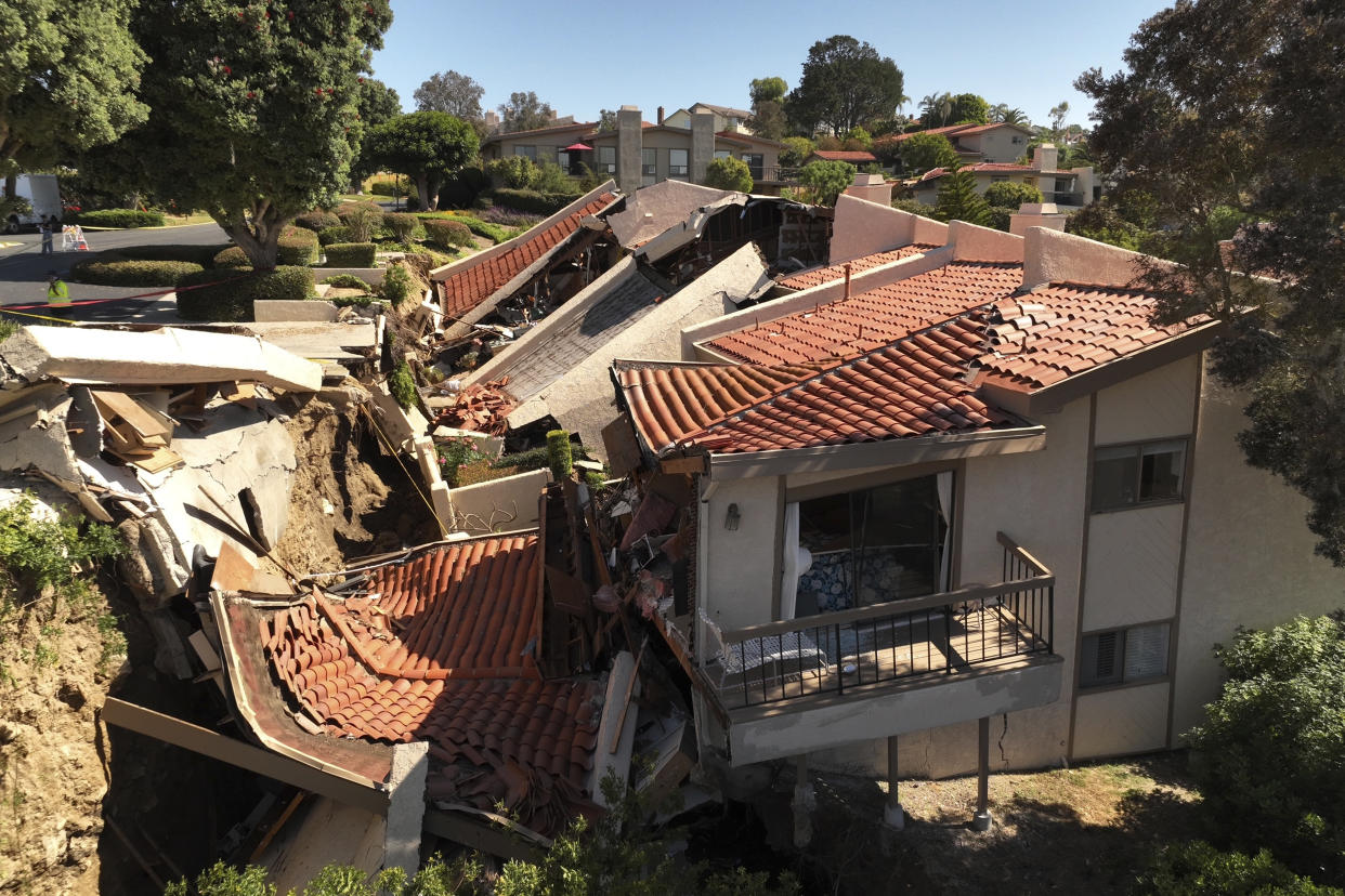 This photo shot with a drone shows damage from earth movement to a property in Rolling Hills Estates, Calif., Monday, July 10, 2023. The homes in the Los Angeles County city of Rolling Hills Estates were hastily evacuated by firefighters Saturday when cracks began appearing in structures and the ground. (Ted Soqui via AP)