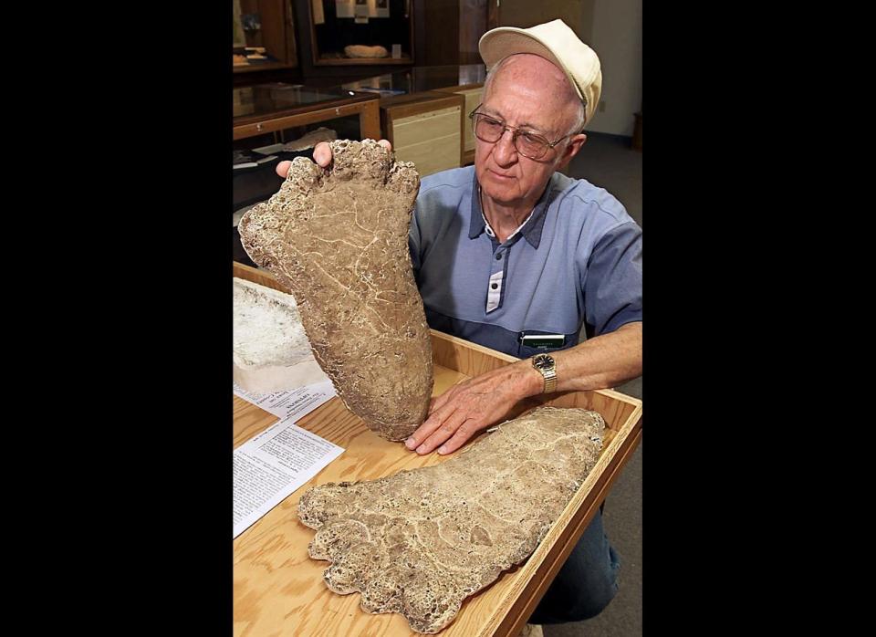 Al Hodgson, a volunteer guide at the Willow Creek-China Flat Museum, holds up a plaster cast of a Bigfoot imprint displayed at the museum's Bigfoot Wing in Willow Creek, Calif., on June 5, 2000. The wing was built to bring tourists interested in the legendary creature to the economically depressed ex-lumber town.