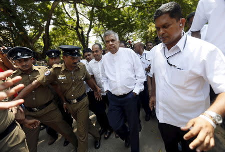 Sri Lanka's Prime Minister Ranil Wickremesinghe (C) arrives at a polling station during a general election in Colombo, August 17, 2015. REUTERS/Dinuka Liyanawatte