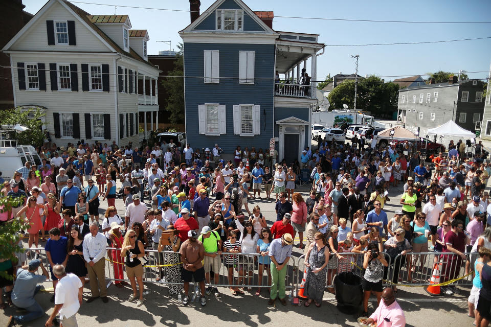 CHARLESTON, SC - JUNE 21:  People stand together in front of the Emanuel African Methodist Episcopal Church as they listen to a broadcast of the Sunday service taking place after a mass shooting at the church killed nine people on June 21, 2015 in Charleston, South Carolina. Dylann Roof, 21 years old, is suspected of killing the nine people during a prayer meeting in the church, which is one of the nation's oldest black churches in Charleston.  (Photo by Joe Raedle/Getty Images)