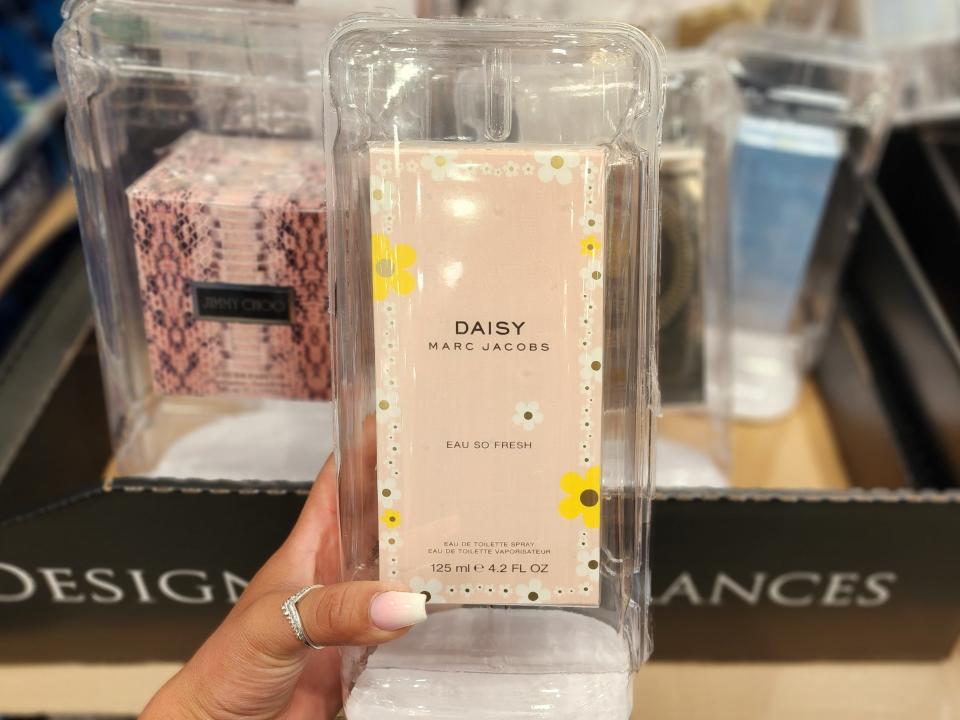 The writer holds Daisy by Marc Jacobs fragrance