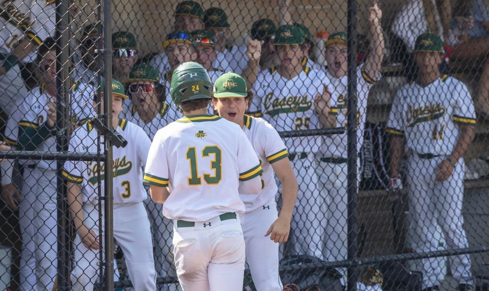 RBC Sean Griggs is greeted at the dug out after scoring first run of game. Red Bank Catholic baseball defeats St. Augustine 8-1 in NJSIAA  South Non-Public A  Semifinal game in Red Bank, NJ on May 31, 2023. 