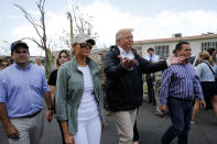 <p>President Donald Trump and first lady Melania Trump walk through a neighborhood damaged by Hurricane Maria in Guaynabo, Puerto Rico, Oct. 3, 2017. (Photo: Jonathan Ernst/Reuters) </p>