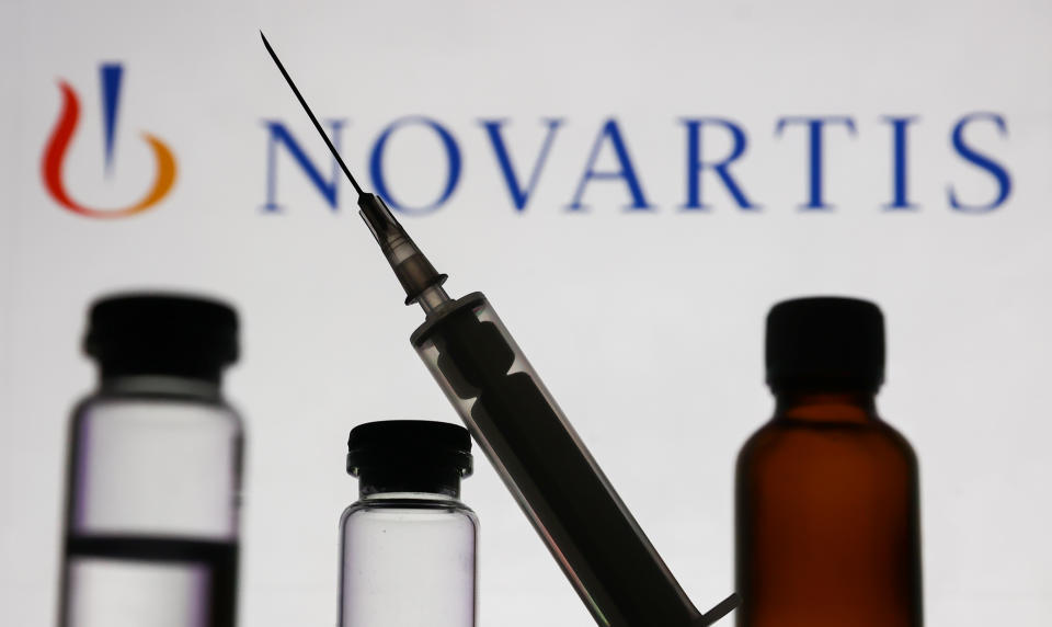 Medical bottles and syringe are seen with Novartis logo displayed on a screen in the background in this illustration photo taken in Krakow, Poland on November 10, 2022. (Photo by Jakub Porzycki/NurPhoto via Getty Images)