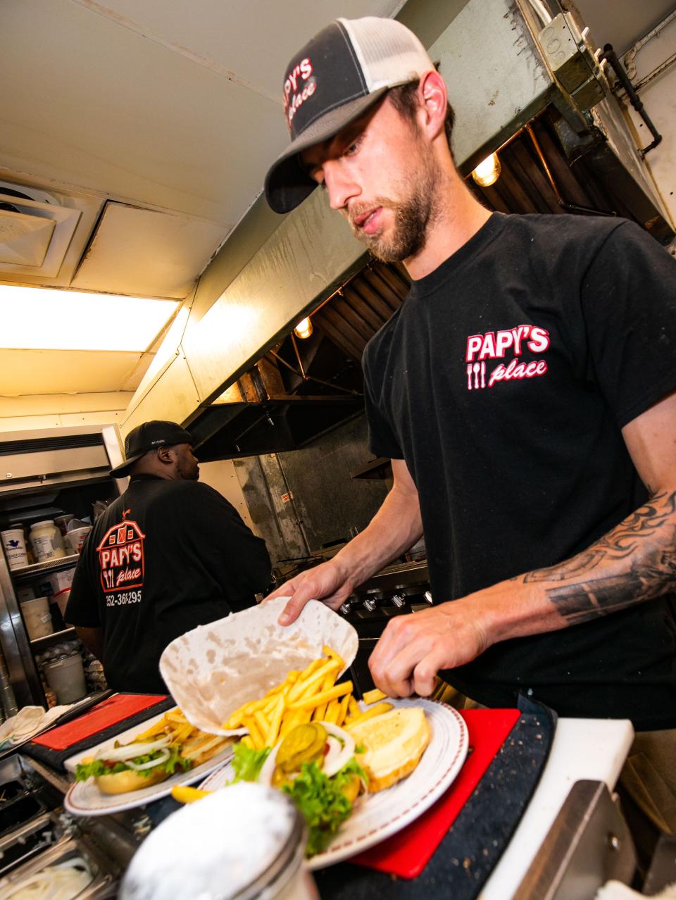 Walker Homan fills a lunch order with a side of fries on Wednesday at Papy's Place in Anthony.