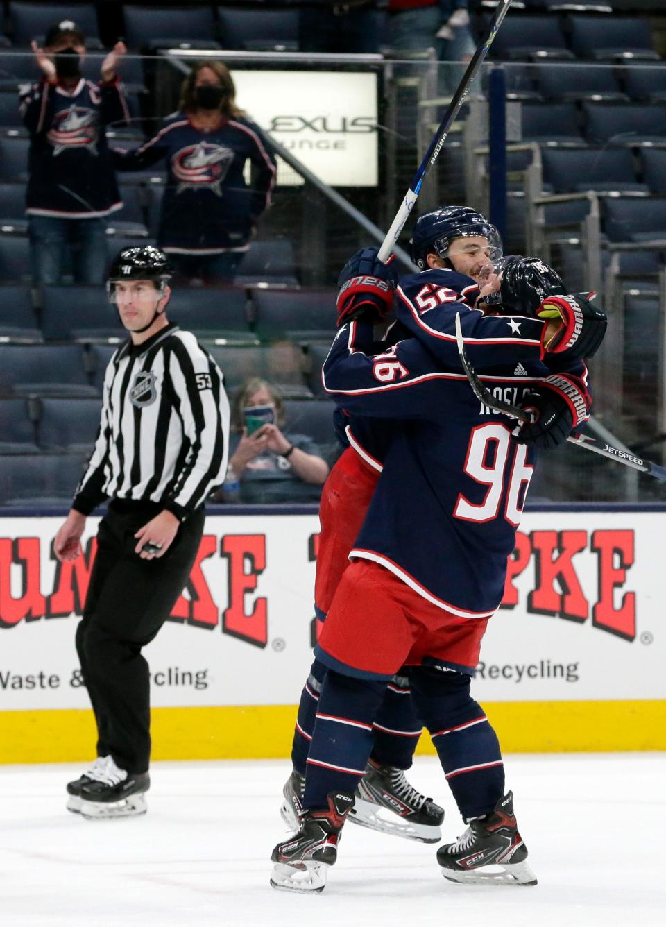 Columbus Blue Jackets center Emil Bemstrom (52) jumps into the arms of Columbus Blue Jackets center Jack Roslovic (96) after scoring his third goal of the game for a hat trick against the Nashville Predators during the third period of Monday's NHL game at Nationwide Arena in Columbus, Ohio, on May 3, 2021.