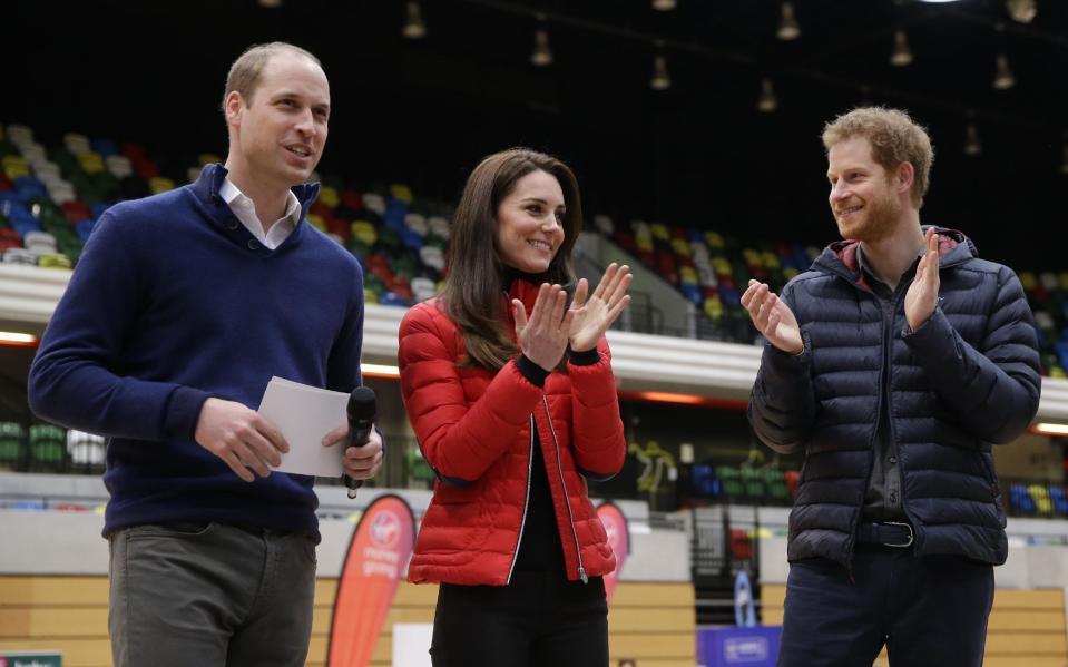Kate, the Duchess of Cambridge, centre and Prince Harry, right, applaud Prince William after he spoke, during a training event to promote the charity Heads Together, at the Queen Elizabeth II Park in London, Sunday, Feb. 5, 2017. (AP Photo/Alastair Grant, Pool)