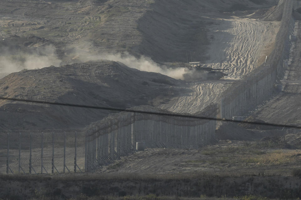 An Israeli tank manoeuvres in the Gaza Strip, as seen from southern Israel, Friday, Nov. 10, 2023. (AP Photo/Leo Correa)