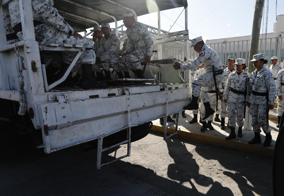 National Guards get on a truck in Ciudad Hidalgo, Mexico, Friday, Jan. 17, 2020 as they deploy along southern border with Guatemala. United States officials are crediting tough measures taken over the past year and cooperation from regional governments for sharply reducing the number of Central American migrants who responded to a call for a new caravan. (AP Photo/Marco Ugarte)