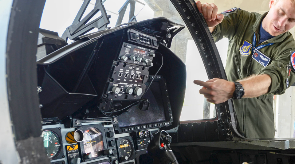 A U.S. Air Force F-15 pilot points out the Passive Attack Display, or PAD, the large multifunction display that slots in where the F-15C’s engine instruments and radar warning receiver were previously installed. <em>U.S. Air Force</em>