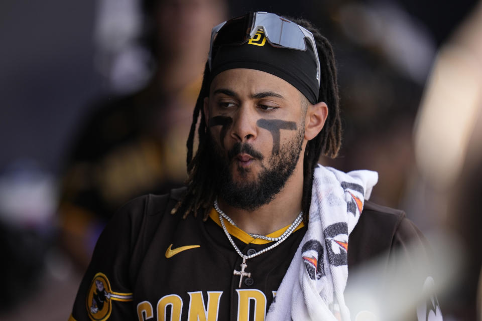 FILE - San Diego Padres' Fernando Tatis Jr. walks in the dugout during the fourth inning of a spring training baseball game against the Cincinnati Reds, March 8, 2023, in Peoria, Ariz. On Thursday, April 20, in downtown Phoenix, Tatis will be announced as the leadoff hitter for the Padres and settle into a batter's box in the big leagues for the first time since the end of the 2021 season. (AP Photo/Abbie Parr, File)