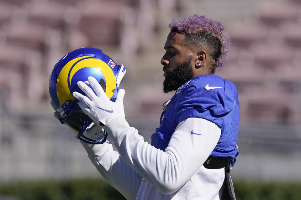 Los Angeles Rams wide receiver Odell Beckham Jr. puts on his helmet during practice for an NFL Super Bowl football game Thursday, Feb. 10, 2022, in Pasadena, Calif. The Rams are scheduled to play the Cincinnati Bengals in the Super Bowl on Sunday. (AP Photo/Mark J. Terrill)