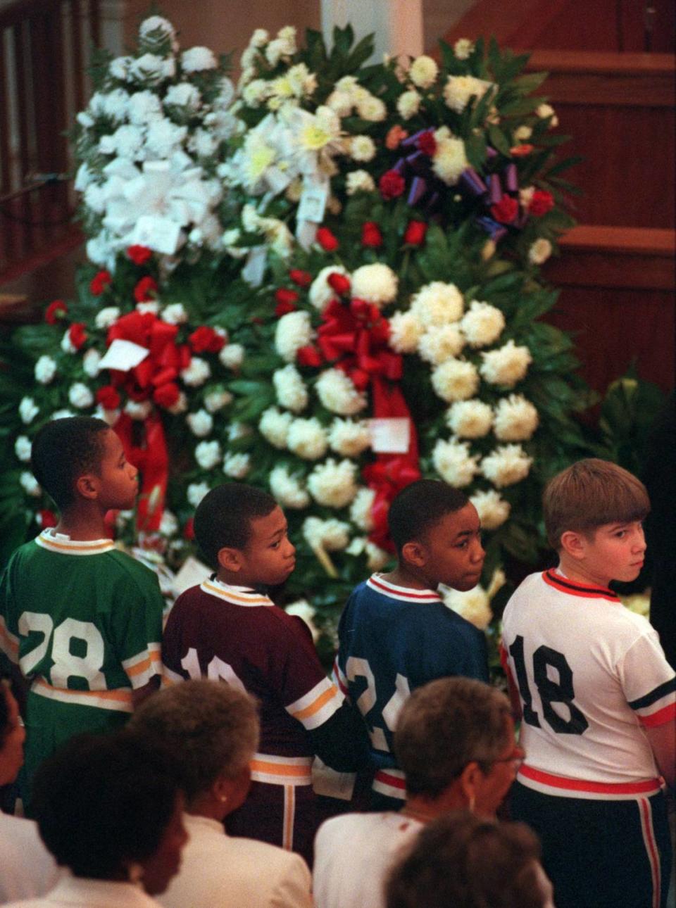 Members of the Buck Leonard Baseball League of Rocky Mount turn to watch Walter “Buck” Leonard’s family as they enter Saint James Baptist Church for the funeral of the baseball legend.