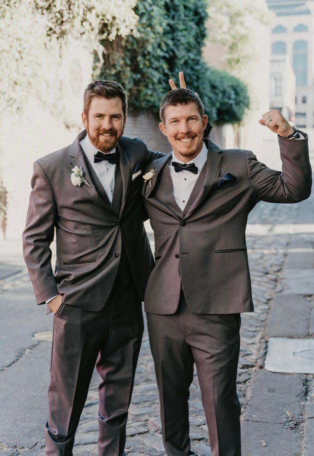 Brian Reisinger, left, and Deputy Kyle Mueller of the Sauk County Sheriff's Department, best men in each others' weddings, in a pose they've taken since wrestling practice in elementary school.