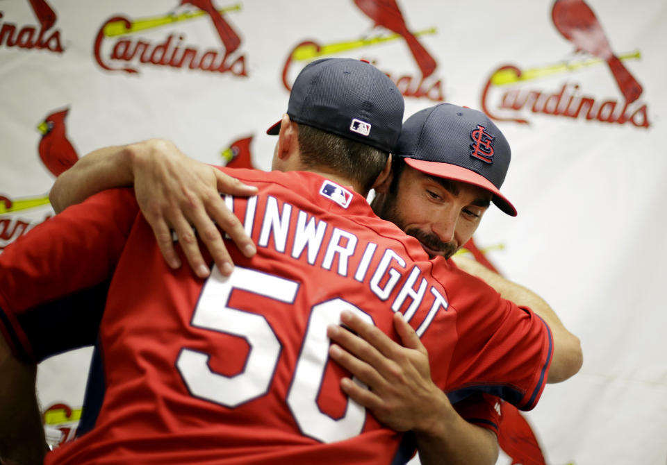 St. Louis Cardinals' Matt Carpenter, right, embraces teammate Adam Wainwright after a news conference at the team's spring training baseball facility, Saturday, March 8, 2014, in Jupiter, Fla. The Cardinals announced Saturday that they have agreed to a six-year contract extension with Carpenter for $52 million. (AP Photo/David Goldman)