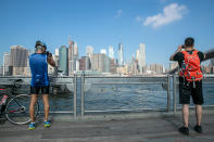 <p>People take photographs of the New York City skyline from Pier 1 at the Brooklyn Bridge Park on Sept. 5, 2018. (Photo: Gordon Donovan/Yahoo News) </p>