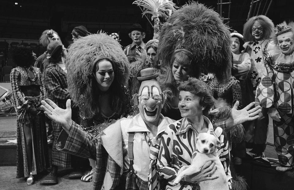 <p>Lou Jacobs, center, whose face has appeared on Ringling Brothers and Barnum and Bailey circus posters for the past 30 years, poses with his wife Jean, holding his dog Knucklehead, and daughters Dolly and Lou Anne, left and right, both circus show girls, before the circus’ performance, May 16, 1973. Jacobs, who had has been making smiles in the circus for 50 years is also celebrating his 70th birthday at the main arena of Madison Square Garden in New York. Dolly Jacobs is 16, Lou Anne, 18. (AP Photo/Anthony Camerano) </p>