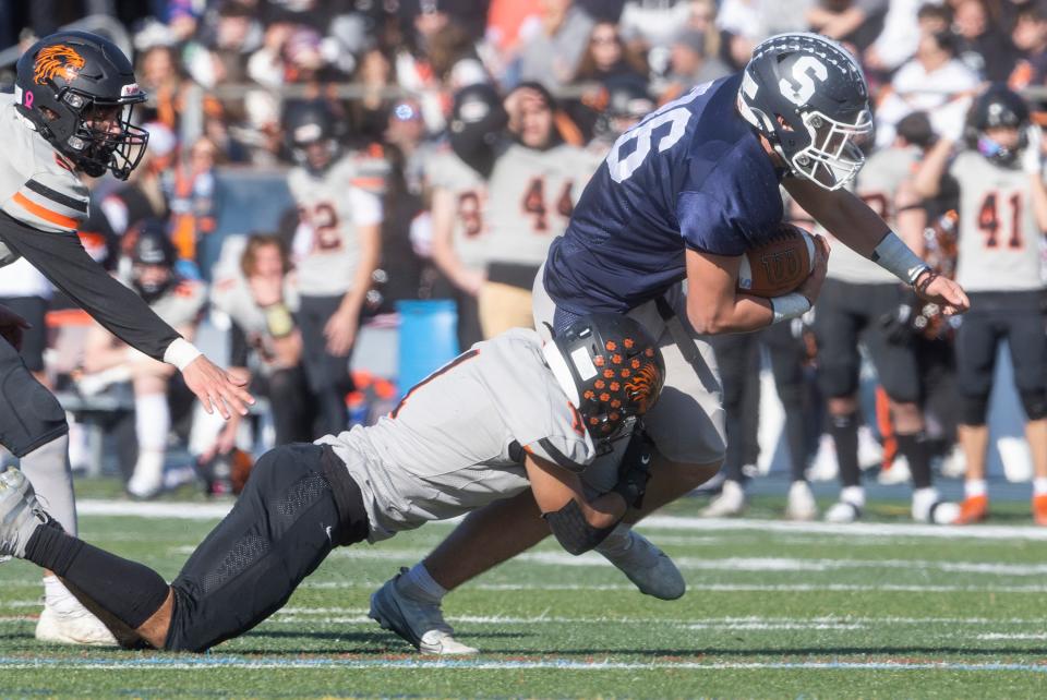 South Liam Curley tries but an’t outrun the reach of North Deer Soto. Middletown South defeats Middletown North in Thanksgiving Day game on November 24, 2022 in Middletown NJ. 