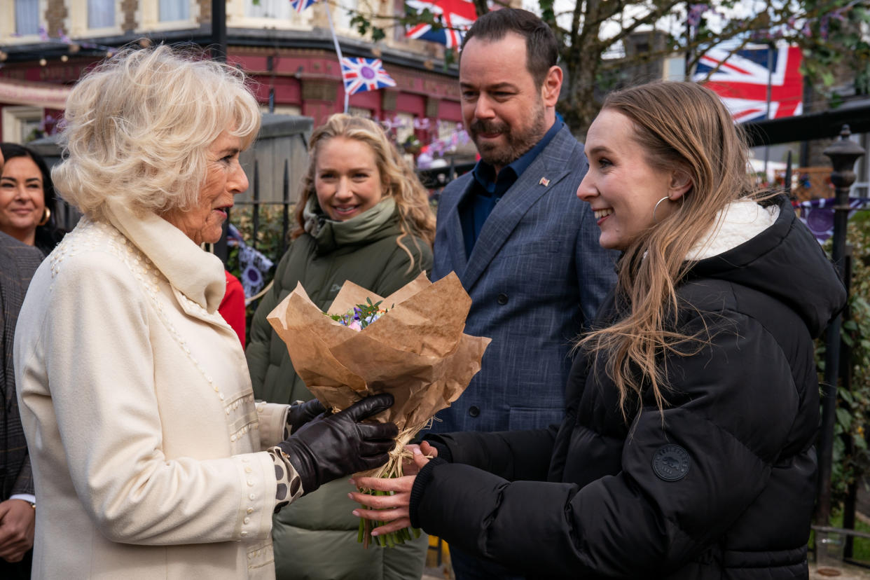 BOREHAMWOOD, ENGLAND - MARCH 31: Camilla, Duchess of Cornwall meets actors (L-R) Maddy Hill, Danny Dyer and Rose Ayling-Ellis during a visit to the set of EastEnders at Elstree Studios on March 31, 2022 in Borehamwood, England. (Photo by Aaron Chown - WPA Pool/Getty Images)