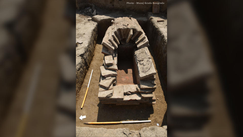 We see a tomb made out of stones. It has an arched roof.