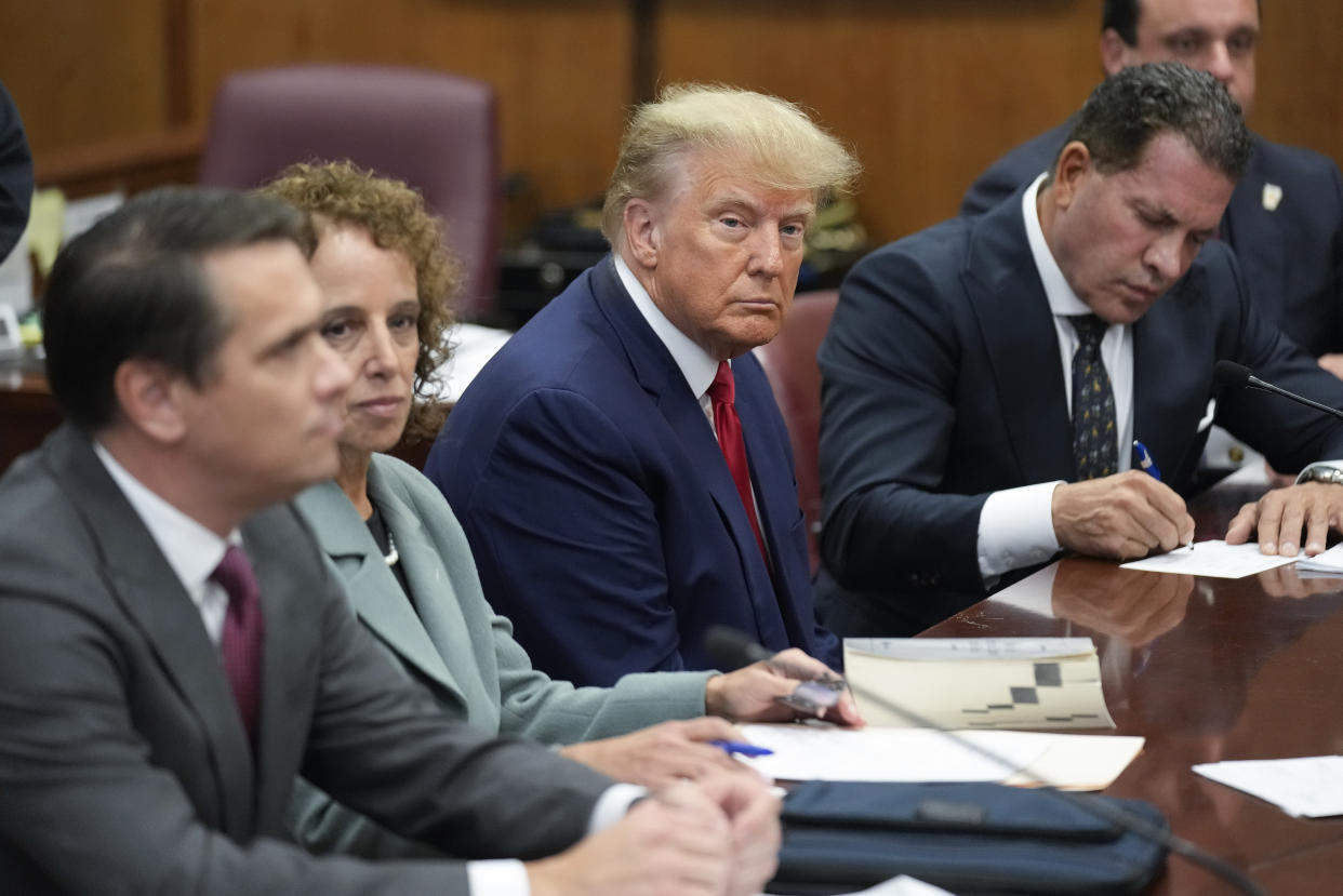 Former President Donald Trump sits at the defense table with his legal team in a Manhattan court, Tuesday, April 4, 2023, in New York.e turned over by prosecutors in the pretrial discovery process to target witnesses or others involved in the case. (Seth Wenig/AP)