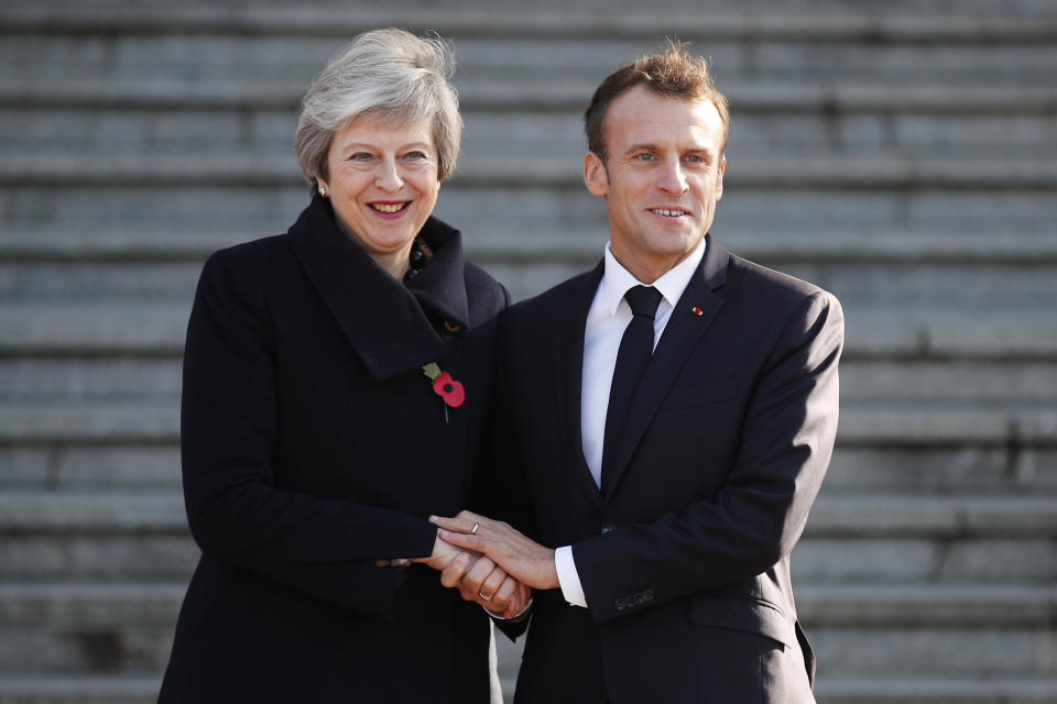 FILE - French President Emmanuel Macron, right, welcomes then-British Prime Minister Theresa May wave before their meeting in Albert, northern France, Friday, Nov. 9, 2018. Former British Prime Minister Theresa May announced Friday, March 8, 2024, that she will quit as a lawmaker when an election is called this year, ending a 27-year parliamentary career that included three years as the nation’s leader during a period roiled by Brexit. (AP Photo/Francois Mori, File)