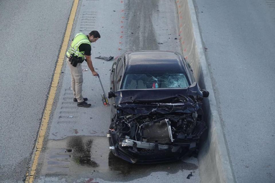 A 29-year-old man involved in a crash got out of his vehicle and was killed by another car early Tuesday on Florida’s Turnpike at the county line between Broward and Palm Beach counties, troopers said. An investigator can be seen by one of the damaged cars.