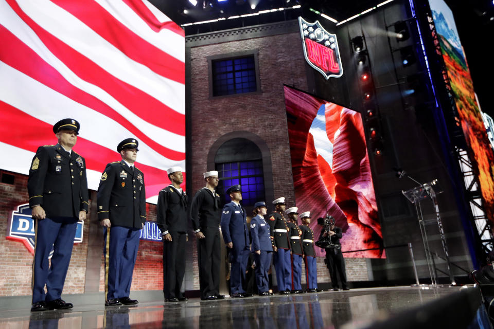 Members of the U.S. military stand on stage during the third round of the NFL football draft, Friday, April 26, 2019, in Nashville, Tenn. (AP Photo/Mark Humphrey)