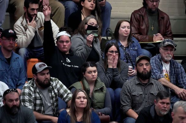 PHOTO: A woman raises her hand with a question during a town hall meeting at East Palestine High School in East Palestine, Ohio, Feb. 15, 2023. (Gene J. Puskar/AP)