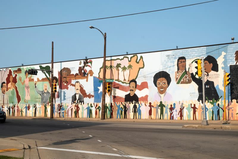 A mural showing Mexican, Puerto Rican, Native American and Black historic icons is displayed near the industrial corridor of Walker Square in Milwaukee