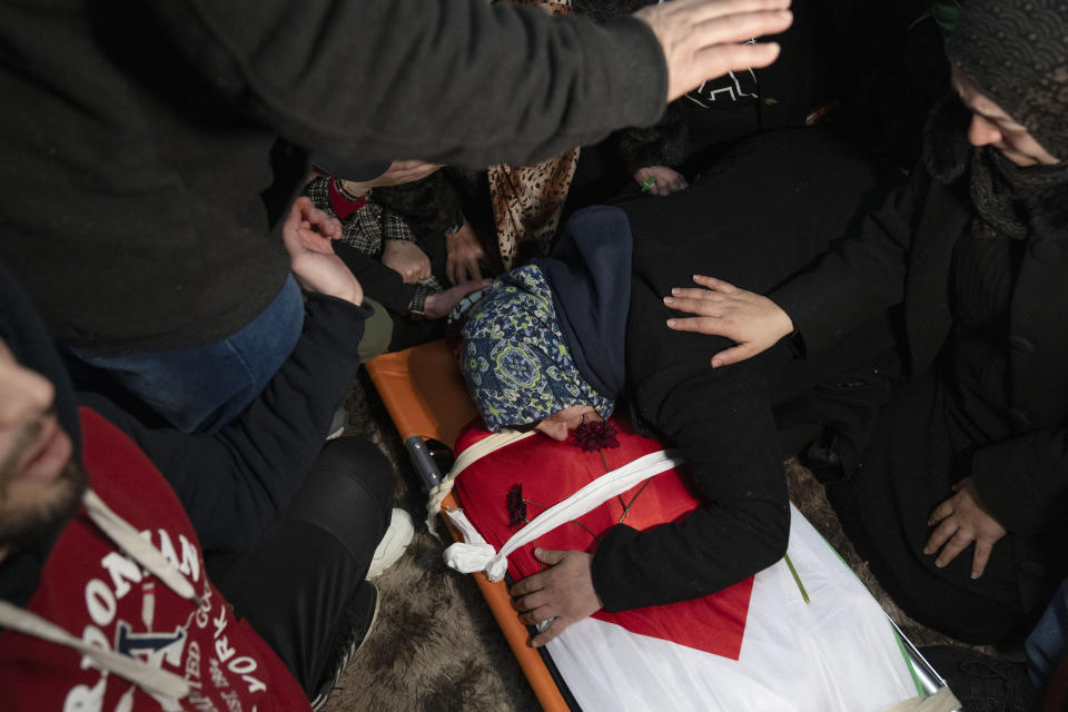 Hanan Issa Khdour, mother of Mohammad Khdour, 17, cries over the body of her son at the family house during his funeral in the West Bank village of Biddu, southwest of Ramallah, Monday, Feb. 12, 2024. Khdour, a U.S. citizen born in Florida, was shot Saturday while driving with a cousin on a hillside by what his family alleges was Israeli fire. (AP Photo/Nasser Nasser)