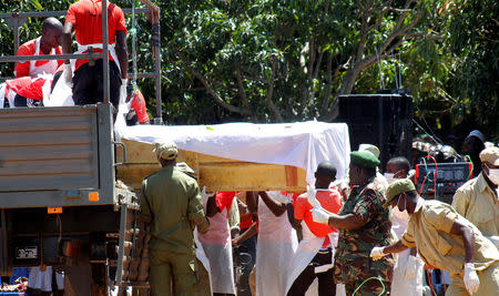 Volunteers carry a coffin containing the dead body of a passenger retrieved after the MV Nyerere ferry overturned off the shores of Ukara Island ahead of burial in Lake Victoria, Tanzania September 23, 2018. REUTERS/Stringer