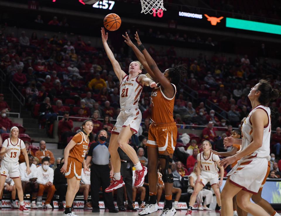 Iowa State's Lexi Donarski (21) shoots around Texas' DeYona Gaston (5) during the first quarter of Wednesday's game at Hilton Coliseum.