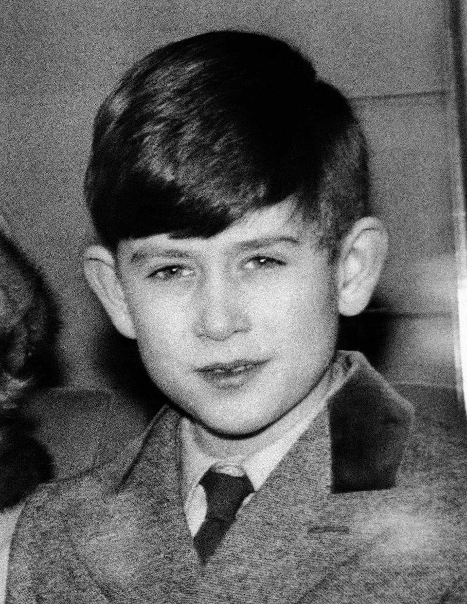 FILE - In this Jan. 24, 1957 file photo, Britain's Prince Charles leaves King's Cross Station, London as the Royal family return to London after their Christmas holidays at Sandringham. Prince Charles turns 70 Wednesday, Nov. 14, 2018, still serving in the heir to the throne role he has filled since he was a young child. (AP Photo, File)