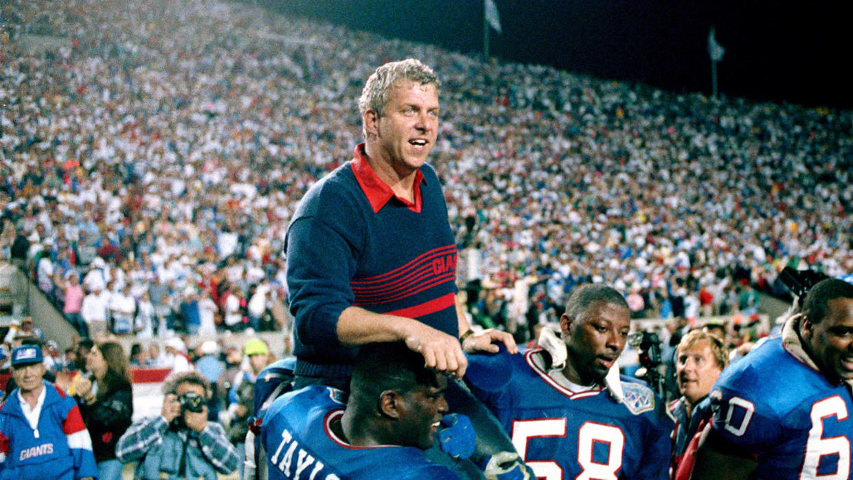 Mandatory Credit: Photo by Ed Reinke/AP/Shutterstock (6545430a)Bill Parcells, Lawrence Taylor, Carl Banks New York Giants coach Bill Parcells is carried on the shoulders of football players Lawrence Taylor (56) and Carl Banks (58) after defeating the Buffalo Bills 20-19 to win Super Bowl XXV in Tampa, FlaCountdown to 50 Super Bowl 25 Football, Tampa, USA.