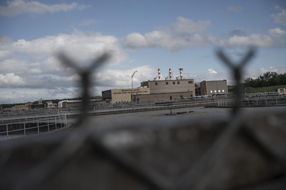 The Metropolitan District Hartford Water Pollution Plant, which houses a sewage sludge incinerator, is seen behind a fence in the South Meadows neighborhood of Hartford, Conn., Tuesday, Sept. 13, 2022. In 2021, the Metropolitan District was fined $298,000 for pollution violations at its sewage sludge incineration facilities. (AP Photo/Wong Maye-E)