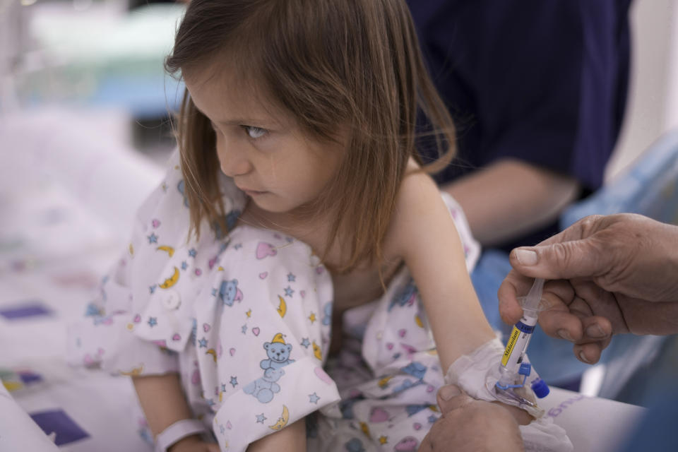 Karina Andreiko, a 5-year-old Ukrainian girl, is prepped for heart surgery by a team led by Dr. Sagi Assa, head of invasive pediatric cardiology, from the Save A Child's Heart non-profit organization, at the Wolfson Medical center in Holon, near Tel Aviv, Israel, Monday, May 2, 2022. Andreiko, received treatment in Israel for a heart defect that she would not have in her war-ravaged home country. (AP Photo/Ariel Schalit)