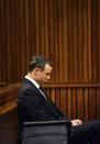 South African Olympic and Paralympic athlete Oscar Pistorius sits in the dock during his murder trial in the North Gauteng High Court in Pretoria June 30, 2014. Pistorius is on trial for murdering his girlfriend Reeva Steenkamp at his suburban Pretoria home on Valentine's Day last year. REUTERS/Phill Magakoe/Pool