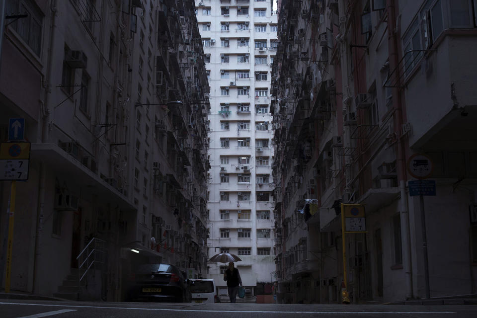 Man walking past buildings